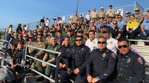 Teen's dad died in the line of duty, so dozens of police came to watch his first football game